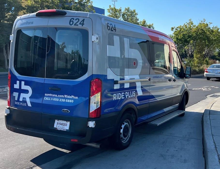 A Ride Plus van is parked along a street in East Palo Alto.