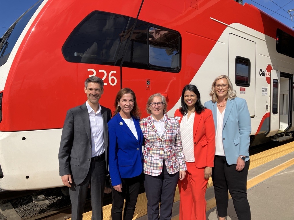 Michelle Bouchard and others in front of electric Caltrain
