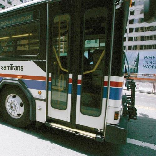 A SamTrans bus drives along El Camino Real