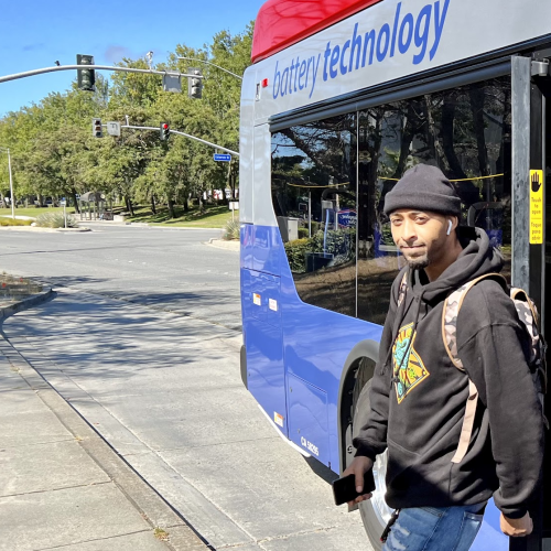 A passenger gets off a battery-electric bus (BEB) in South San Francisco (SSF)