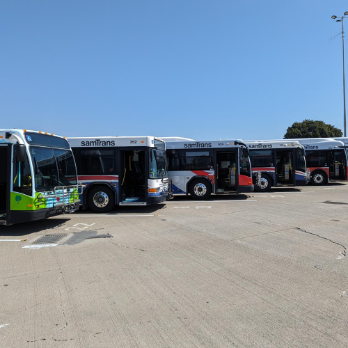 Several SamTrans buses parked in lot