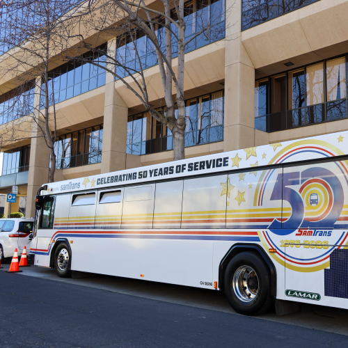 The first of two 50th Aniversary wrapped SamTrans buses is displayed in front of the agency's headquarters in San Carlos.